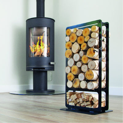 One of Ardour's Classic metal log baskets in jet black. It is a tall rectangular shape with two compartments; A small one at the bottom to store kindling and a large one above to store the logs. Its compact design allows logs to be stored in a smaller footprint than a traditional wicker basket.