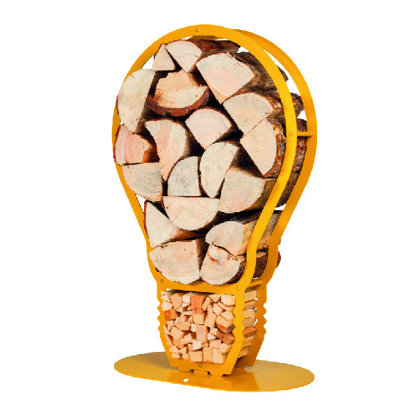 One of Ardour's light bulb shaped metal log baskets in honey yellow. It is a profile of a screw-in style light bulb attached to a base-plate. The design has two compartments; A small one at the top to store kindling and a large one for the main body of the bulb to store the logs. 